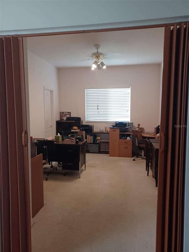 office area featuring ceiling fan and light colored carpet