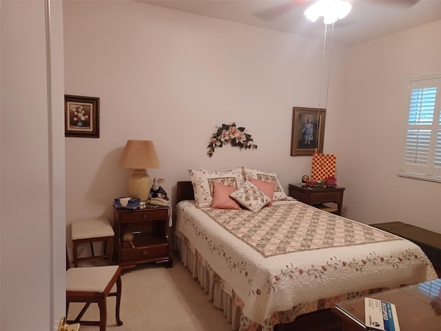 bedroom featuring ceiling fan and light carpet