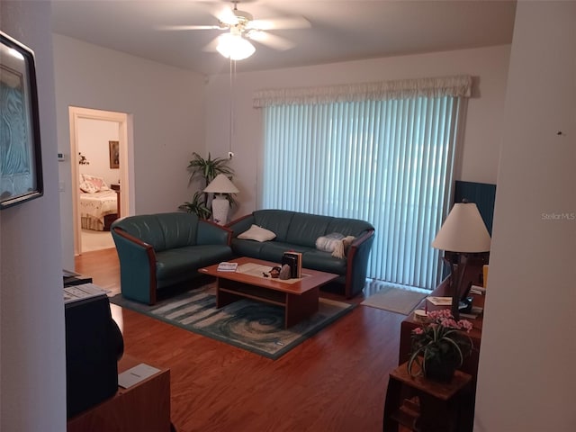 living room with wood-type flooring and ceiling fan