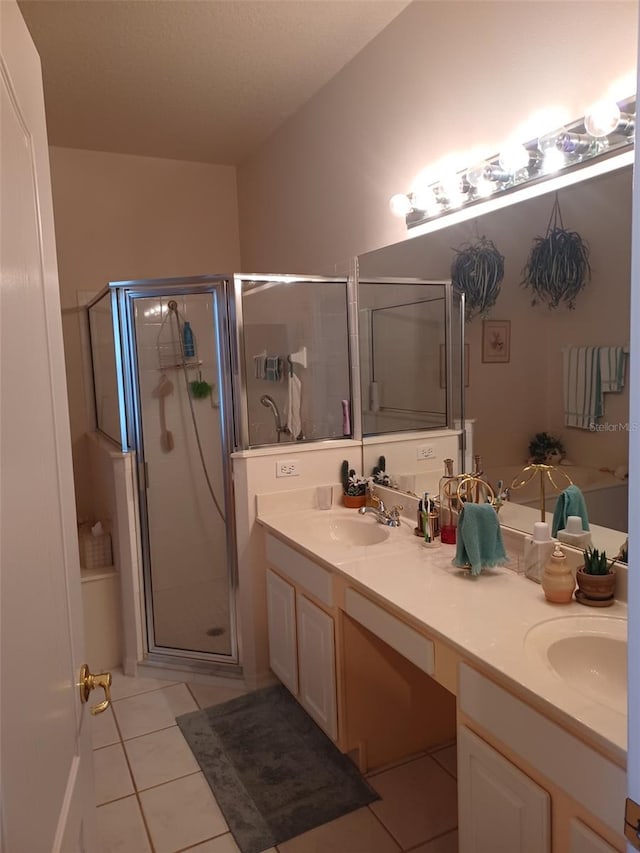 bathroom with vanity, a shower with shower door, and tile patterned floors