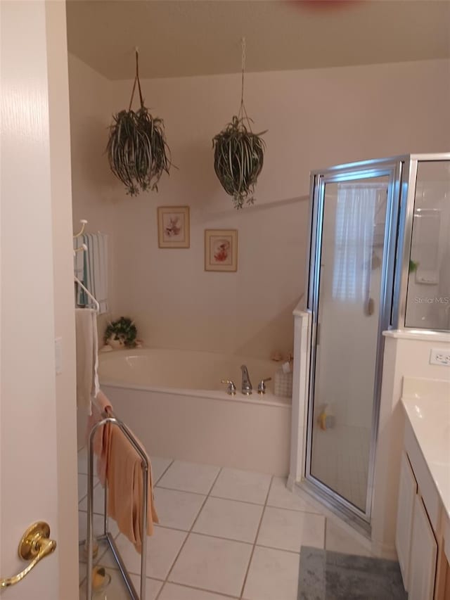 bathroom with independent shower and bath, vanity, and tile patterned flooring