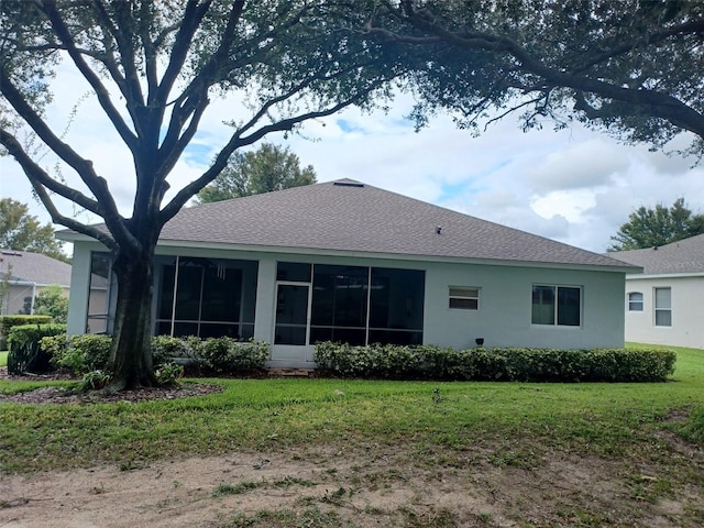 back of house featuring a sunroom and a yard