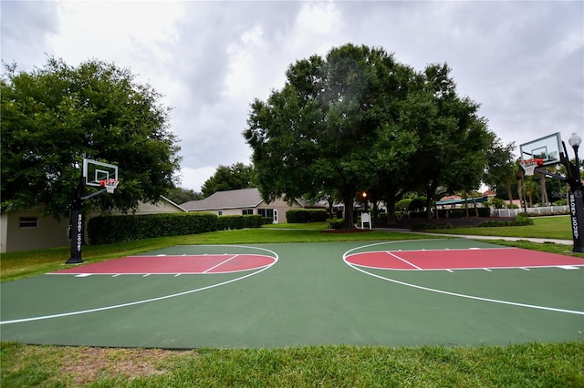 view of sport court featuring a yard