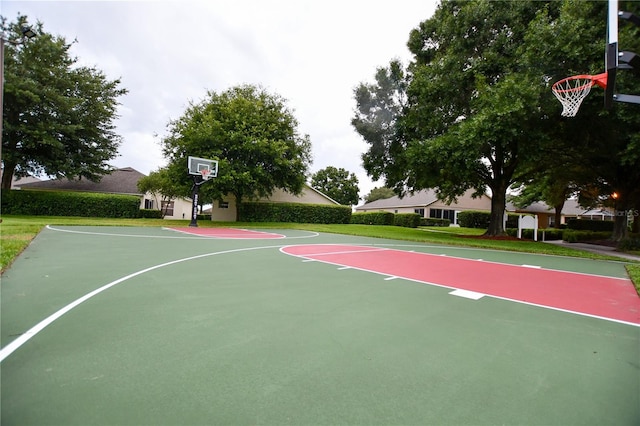 view of basketball court with a lawn