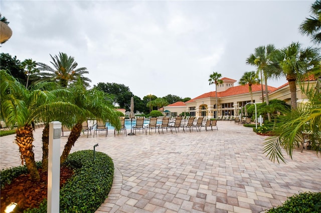 surrounding community featuring a swimming pool and a patio