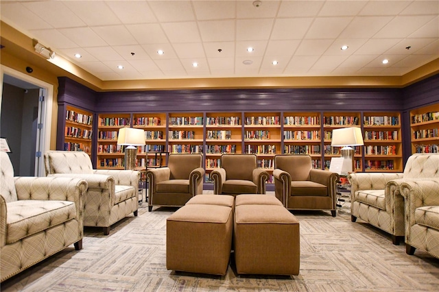 cinema room featuring built in shelves and light carpet