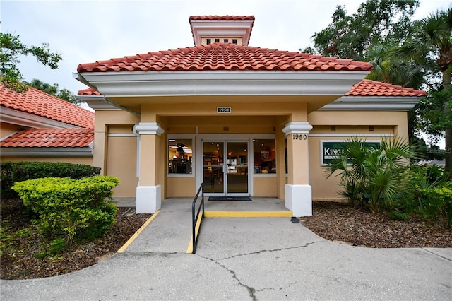 view of exterior entry featuring covered porch