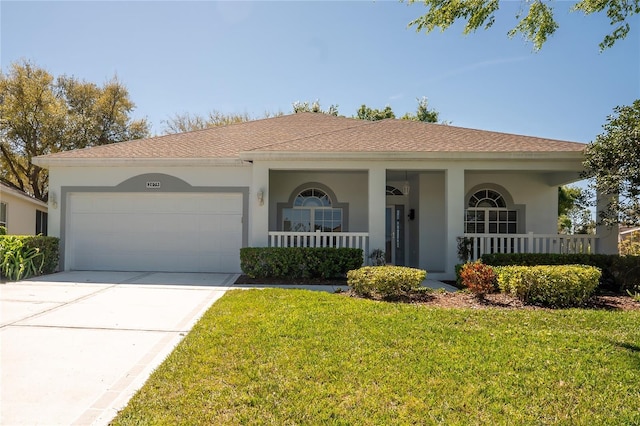 view of front of house with a garage, stucco siding, driveway, and a front yard