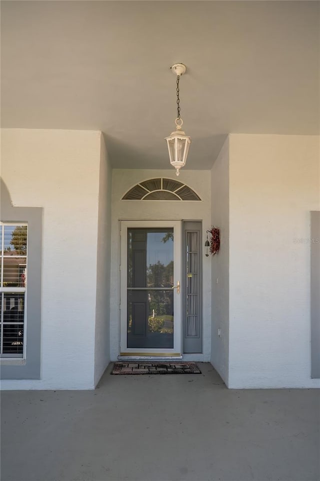 view of exterior entry featuring stucco siding