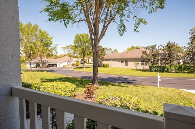 view of yard with a residential view and a balcony