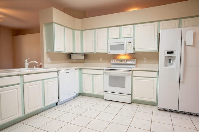 kitchen featuring white appliances, white cabinetry, light countertops, and a sink