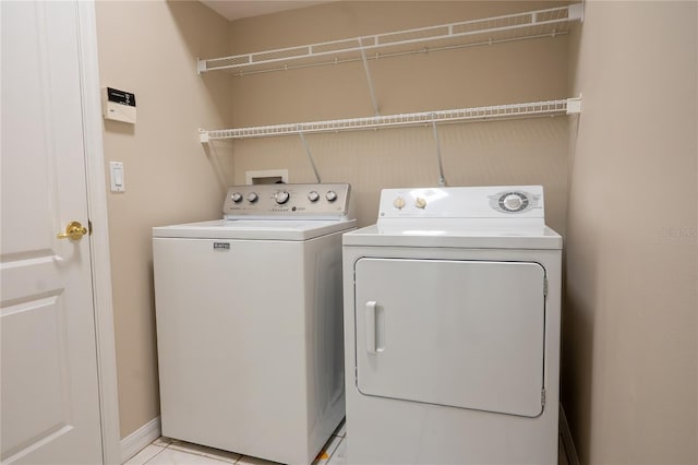 washroom with light tile patterned floors, laundry area, and separate washer and dryer