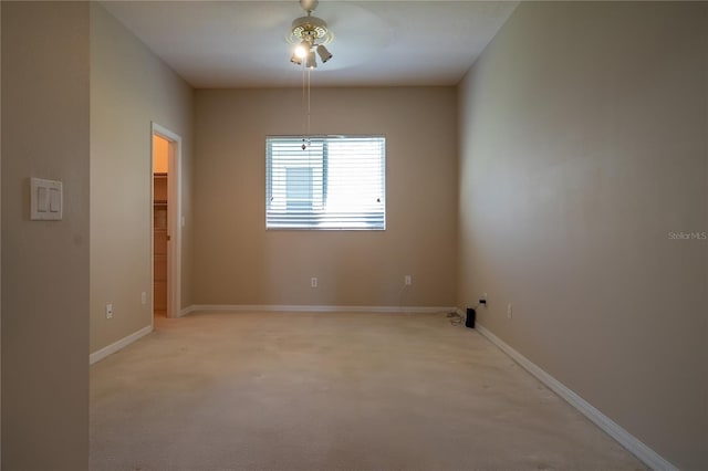 spare room with light colored carpet and baseboards