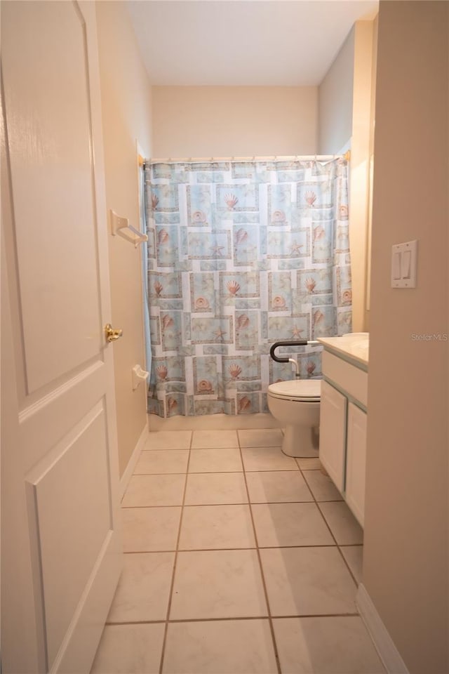 bathroom featuring vanity, tile patterned floors, toilet, and a shower with shower curtain