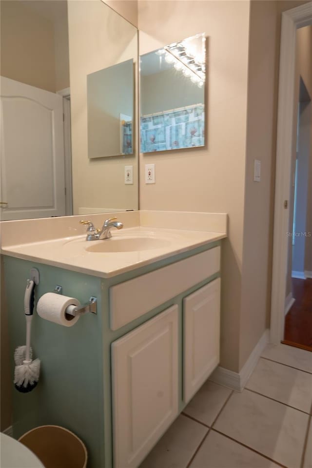 bathroom featuring tile patterned floors, vanity, and baseboards