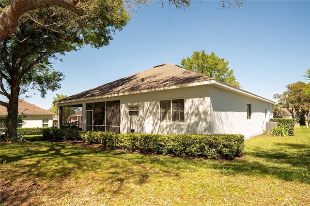 back of property with cooling unit, a lawn, and a sunroom