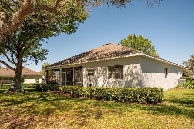 rear view of property featuring a yard, central AC unit, and a sunroom