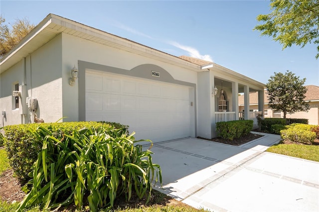 view of home's exterior featuring stucco siding, driveway, and an attached garage