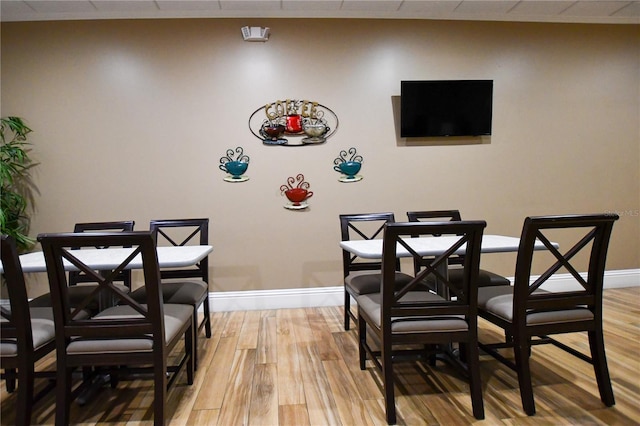 dining space featuring baseboards and light wood-style floors