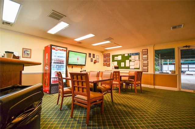 dining area with visible vents and dark carpet