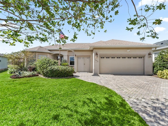 ranch-style home with a front lawn and a garage