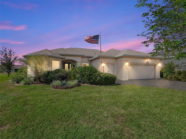 view of front facade with a lawn and a garage