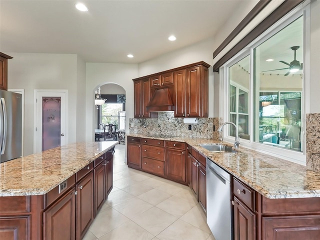 kitchen featuring backsplash, stainless steel appliances, sink, and plenty of natural light