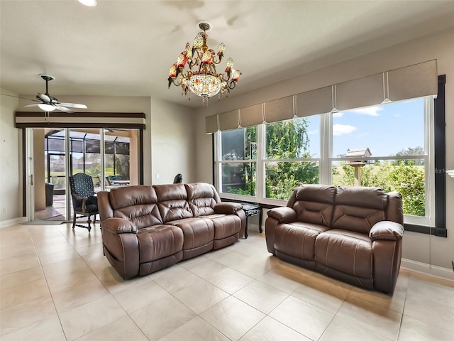 tiled living room with ceiling fan with notable chandelier and a wealth of natural light