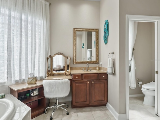 bathroom featuring a bathtub, toilet, tile patterned floors, and vanity