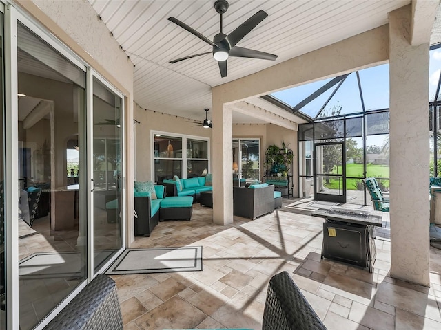 sunroom featuring ceiling fan and wooden ceiling