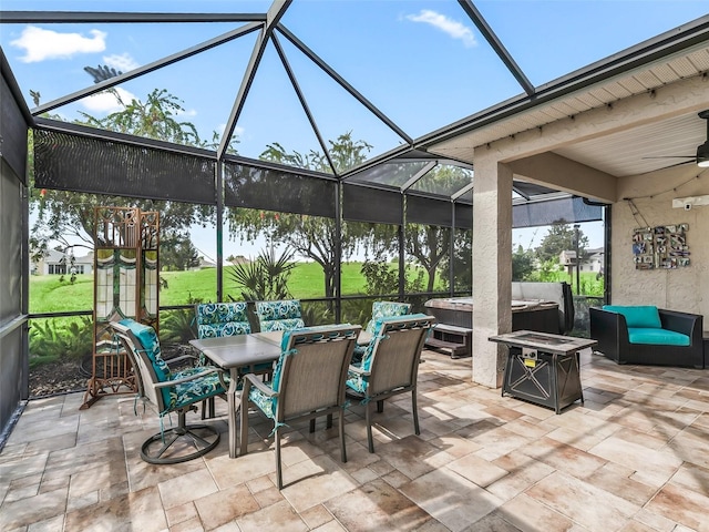 view of patio / terrace with an outdoor living space with a fire pit, glass enclosure, and ceiling fan