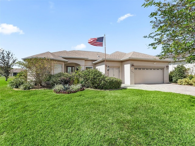 view of front of house with a front yard and a garage