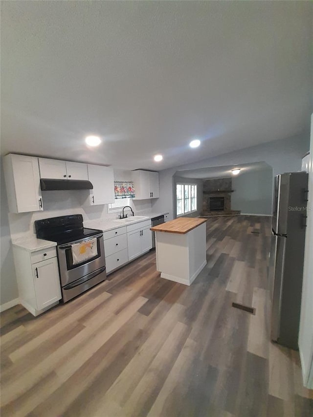 kitchen featuring butcher block countertops, sink, white cabinets, and appliances with stainless steel finishes