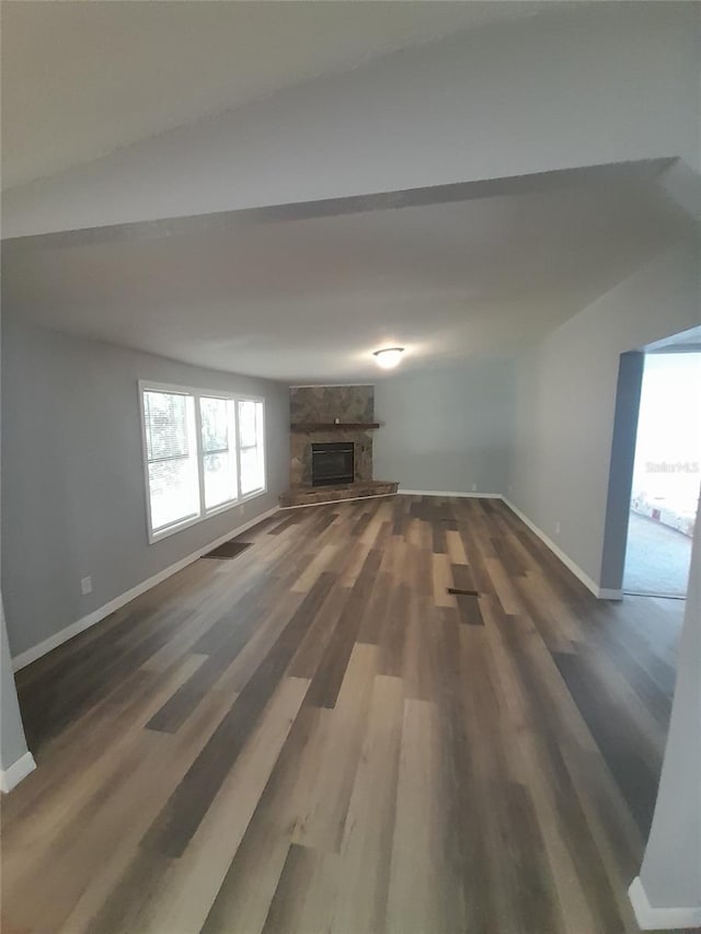 unfurnished living room with dark hardwood / wood-style floors and a fireplace