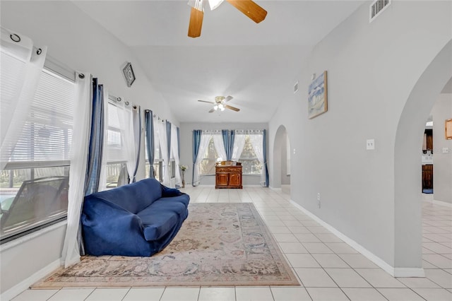 living area featuring vaulted ceiling, ceiling fan, and light tile patterned flooring