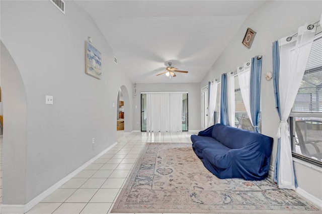 tiled living room featuring a healthy amount of sunlight, vaulted ceiling, and ceiling fan