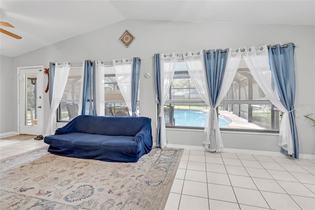 sitting room with a healthy amount of sunlight, lofted ceiling, light tile patterned flooring, and ceiling fan