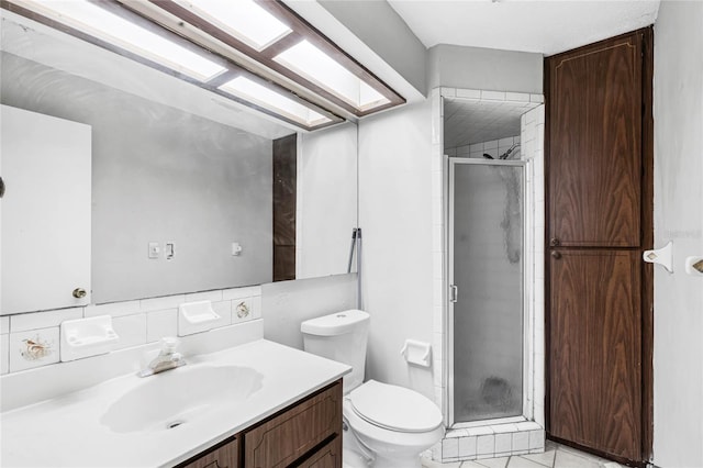 bathroom with walk in shower, vanity, tile patterned flooring, and toilet