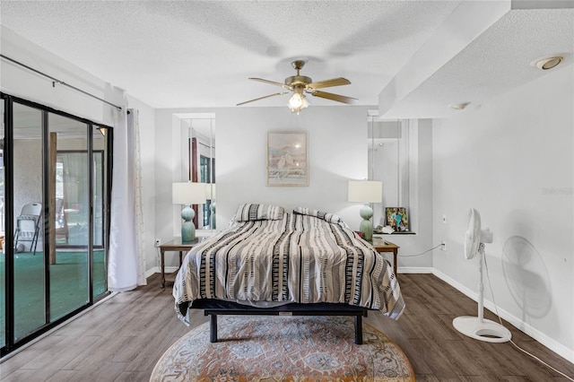 bedroom with ceiling fan, multiple windows, access to outside, and hardwood / wood-style floors