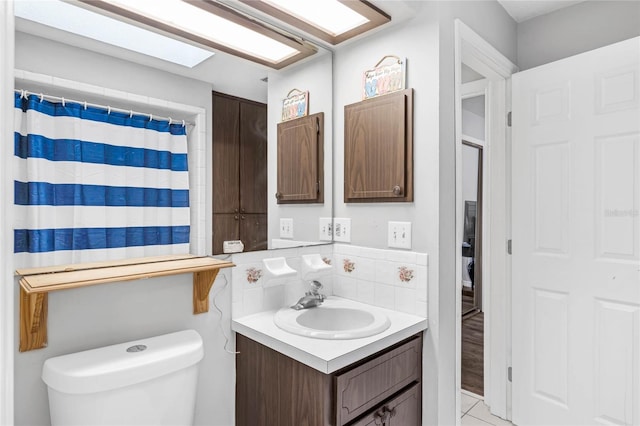 bathroom with tile patterned floors, vanity, and toilet