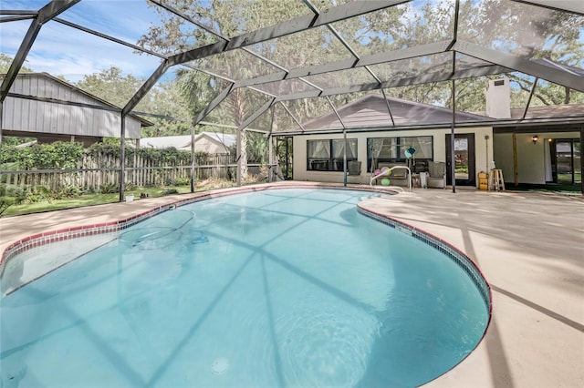 view of swimming pool featuring a lanai and a patio area