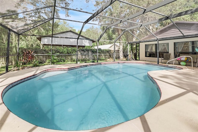 view of swimming pool with a lanai and a patio area