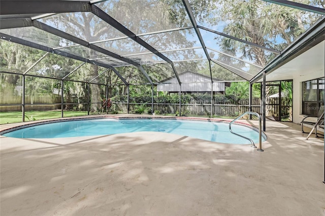 view of swimming pool with a patio and glass enclosure