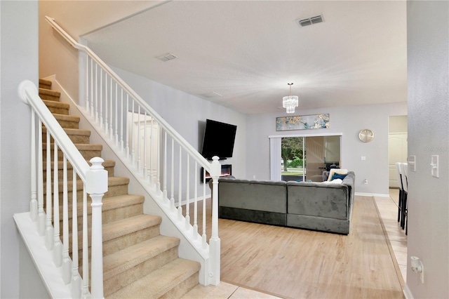 living room featuring an inviting chandelier and hardwood / wood-style flooring