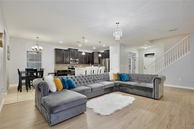 living room featuring light hardwood / wood-style floors and a chandelier