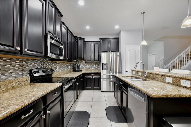 kitchen featuring light tile patterned flooring, sink, stainless steel appliances, backsplash, and decorative light fixtures