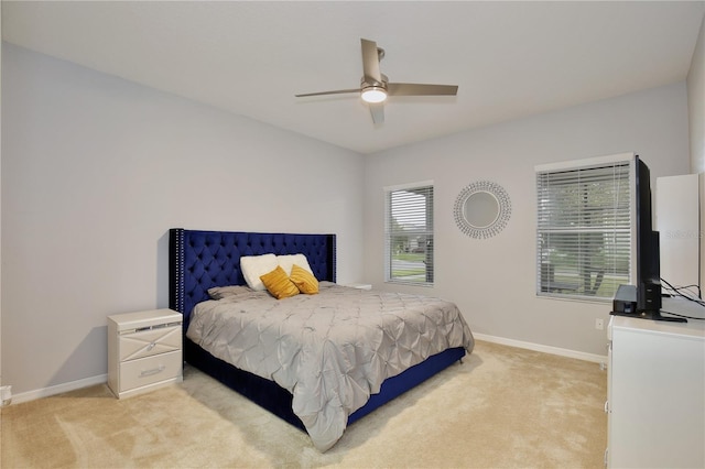 bedroom with ceiling fan and light carpet