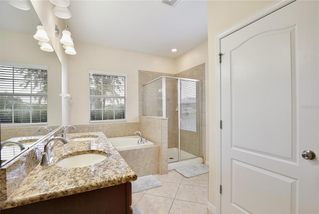 bathroom featuring shower with separate bathtub, tile patterned flooring, a healthy amount of sunlight, and vanity