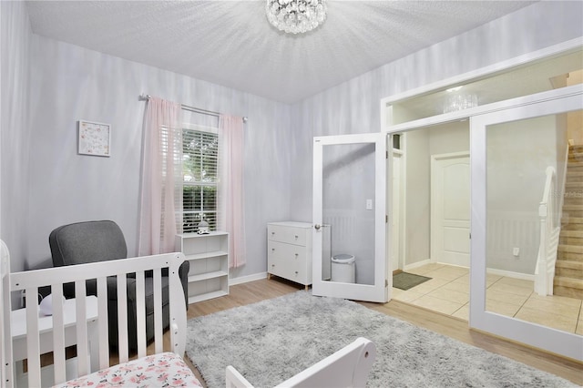 bedroom with wood-type flooring and a textured ceiling