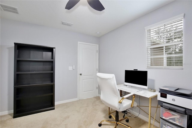 carpeted office space with ceiling fan